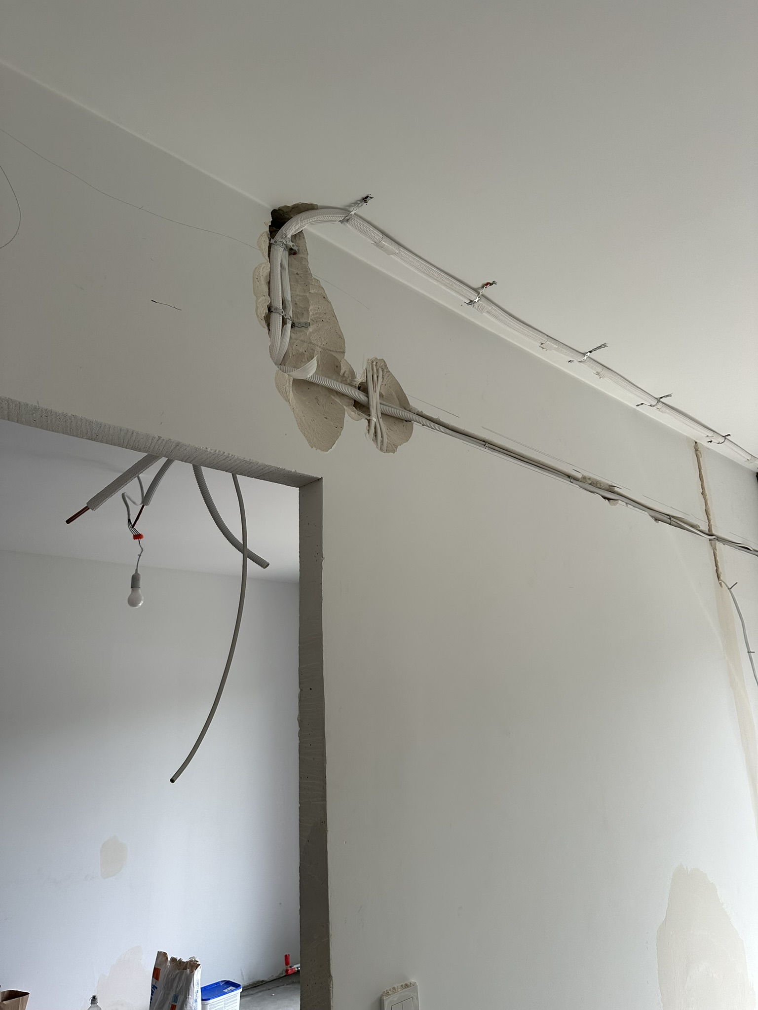 Trasa instalacji klimatyzacyjnej prowadzona przy suficie i w bruzdach przed wykończeniem ścian.